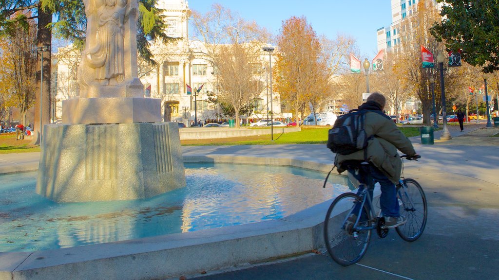 Cesar Chavez Park which includes a city, a statue or sculpture and cycling