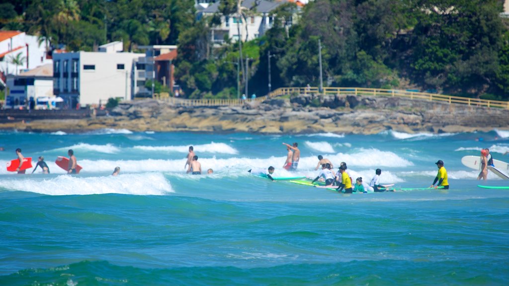 Manly Beach which includes general coastal views, surfing and a coastal town