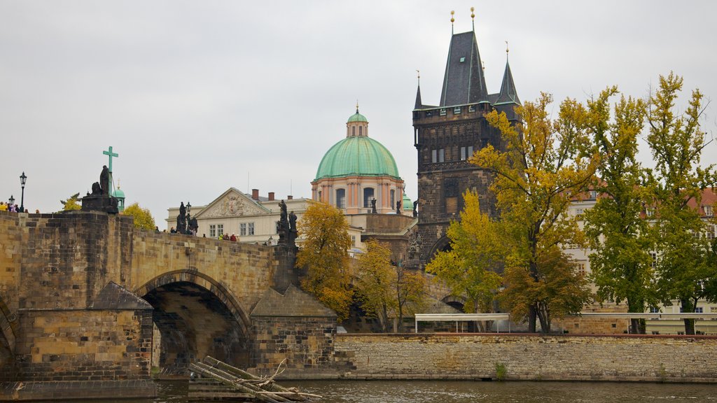 Charles Bridge featuring a bridge, a church or cathedral and a river or creek