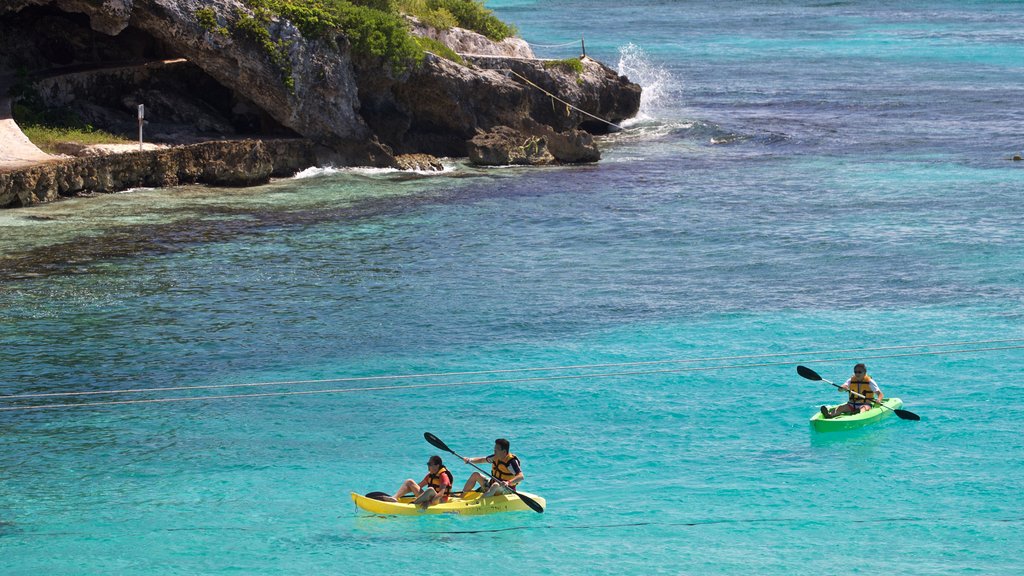 Isla Mujeres showing general coastal views and kayaking or canoeing as well as a small group of people