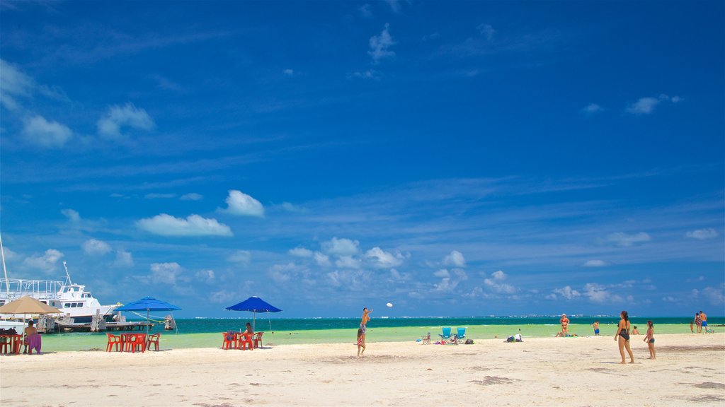 Playa Langosta showing general coastal views and a beach as well as a small group of people