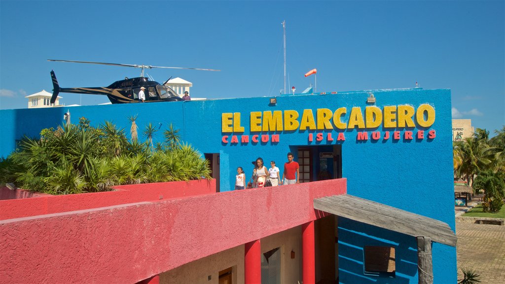 Playa Linda showing signage as well as a family