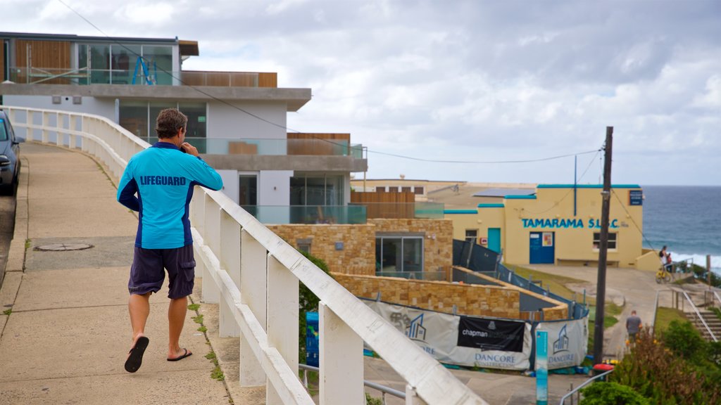 Tamarama Beach showing a coastal town and general coastal views as well as an individual male