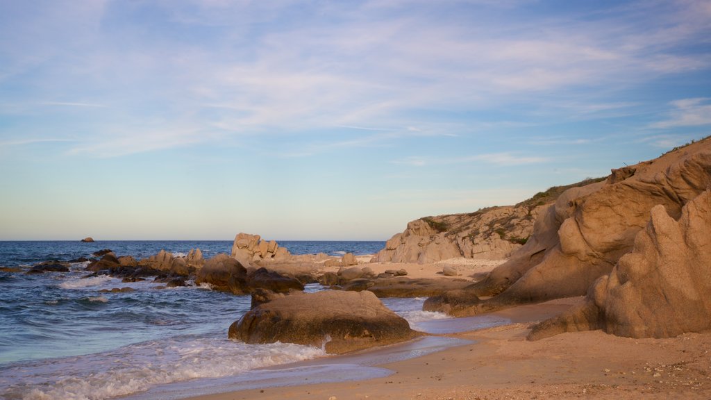 Los Arbolitos Beach which includes rocky coastline, a sunset and a beach