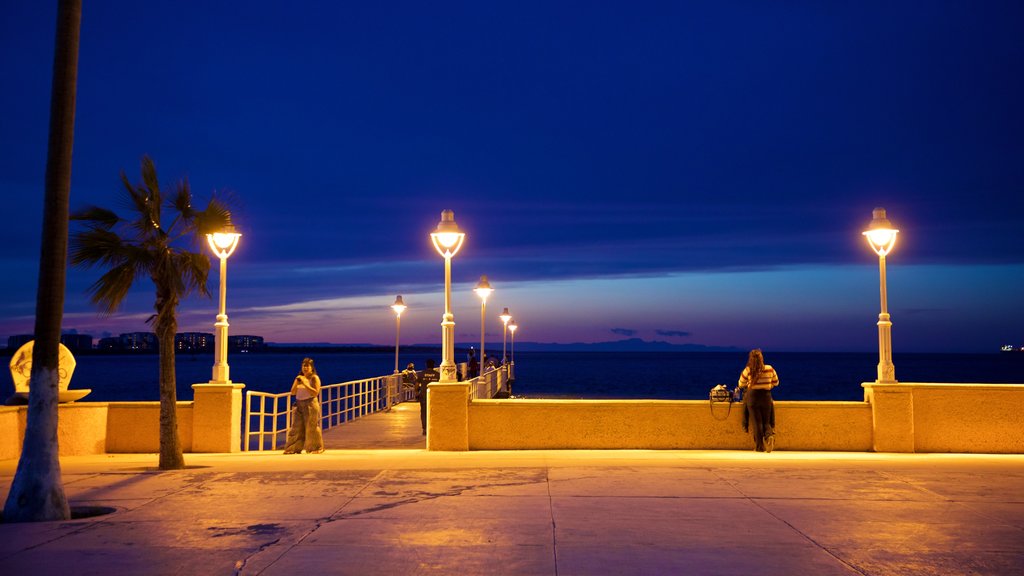 Malecon Kiosk featuring night scenes and general coastal views