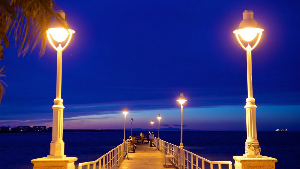 Malecon Kiosk featuring night scenes