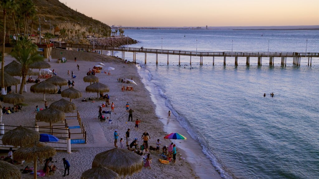 Playa El Coromuel which includes a beach, general coastal views and a sunset