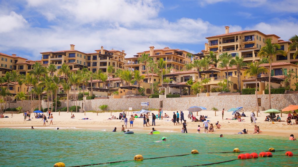 Medano Beach which includes a coastal town, a sandy beach and general coastal views