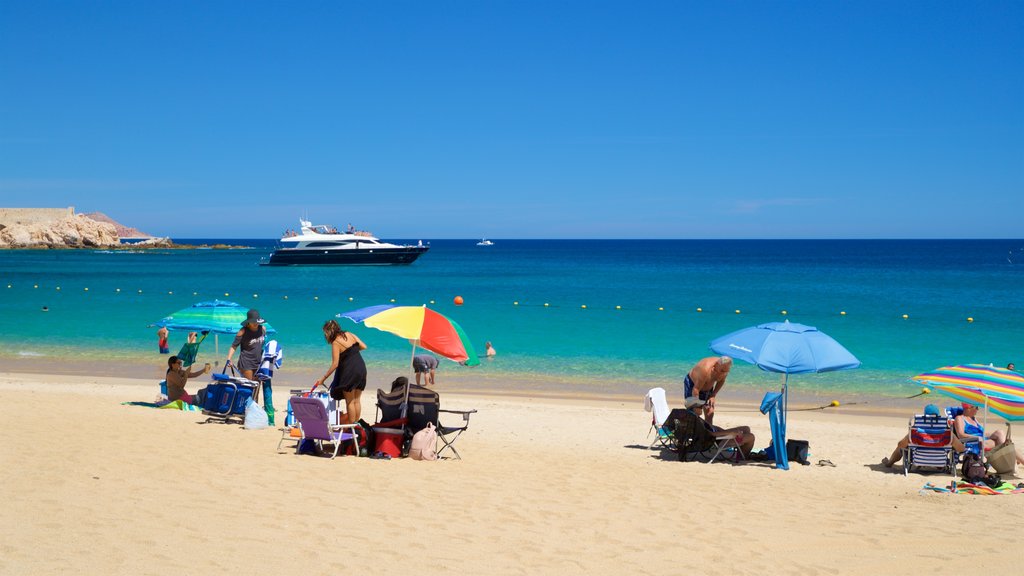 Chileno Beach which includes general coastal views and a beach as well as a small group of people