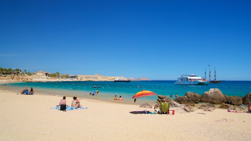 Chileno Beach showing a beach and general coastal views as well as a small group of people