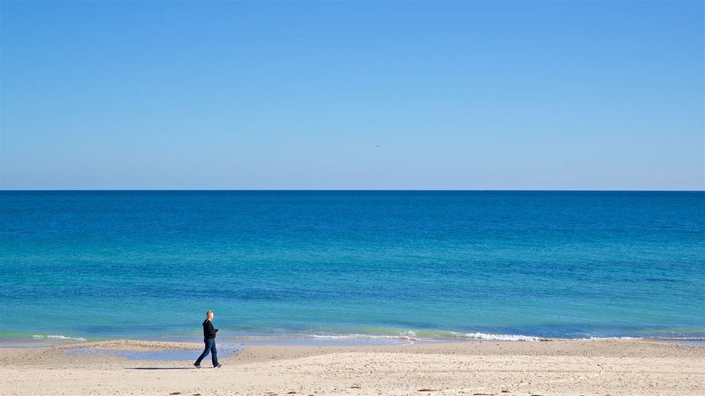 West Beach featuring a sandy beach and general coastal views as well as an individual male