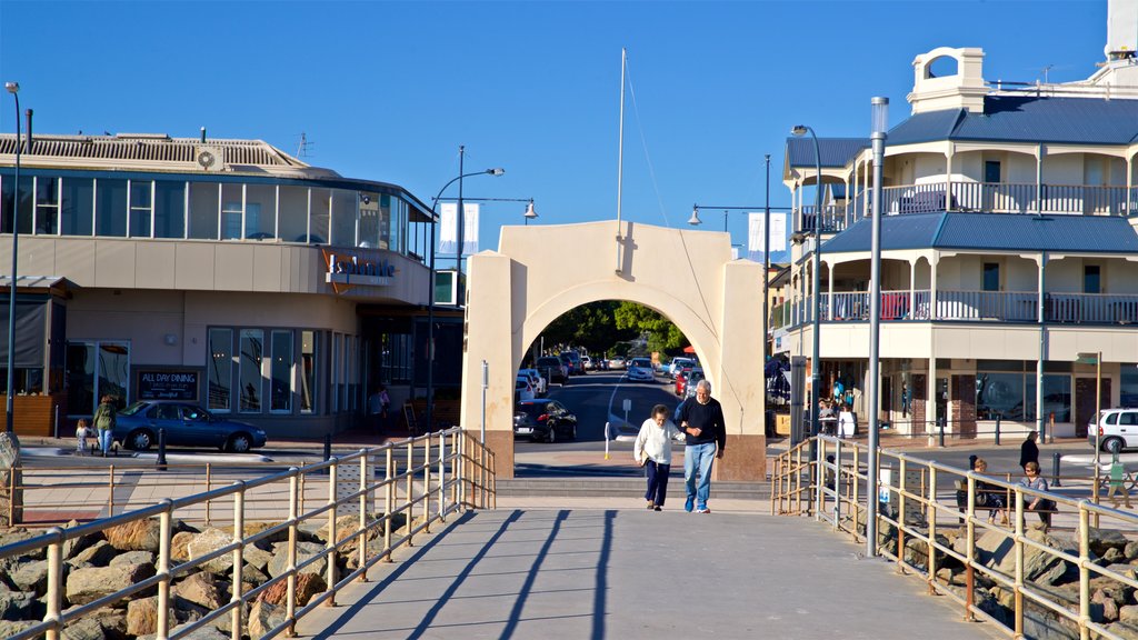 Brighton Beach showing a coastal town as well as a couple