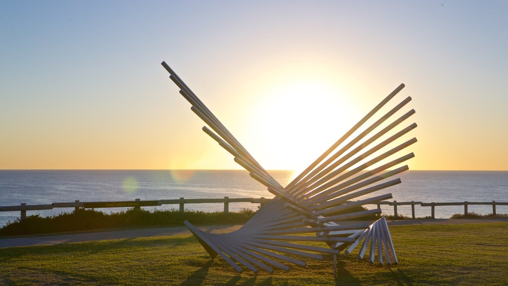 Cottesloe Beach showing outdoor art, general coastal views and a sunset