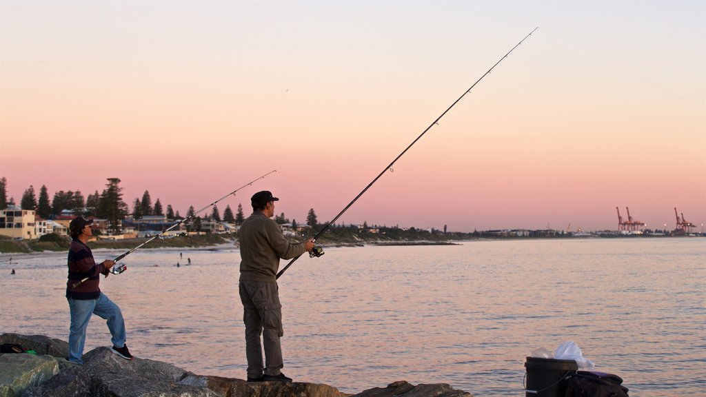 Cottesloe Beach which includes a sunset, general coastal views and fishing