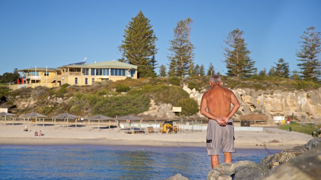 Cottesloe Beach which includes general coastal views as well as an individual male