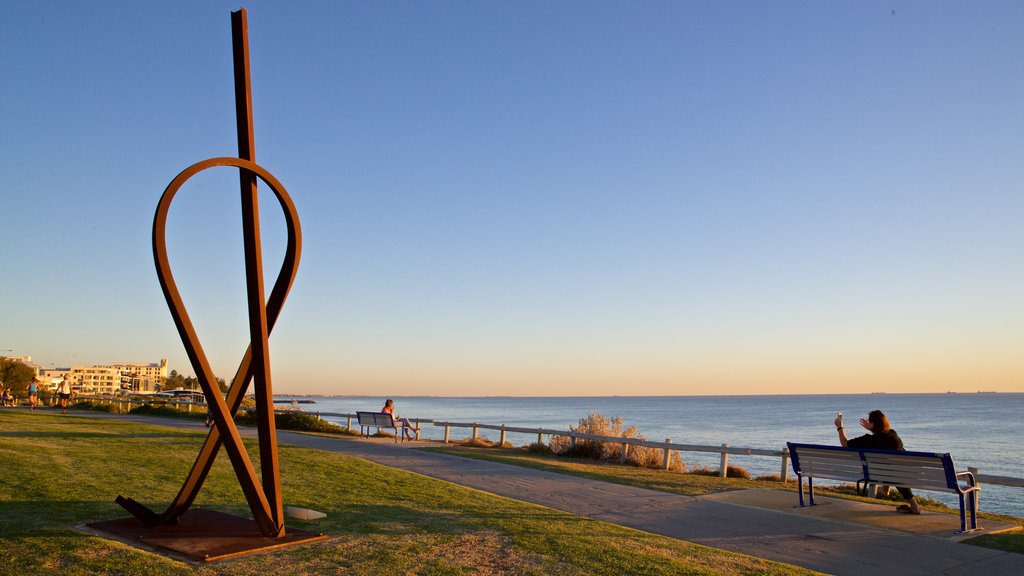 Cottesloe Beach showing general coastal views, a sunset and outdoor art