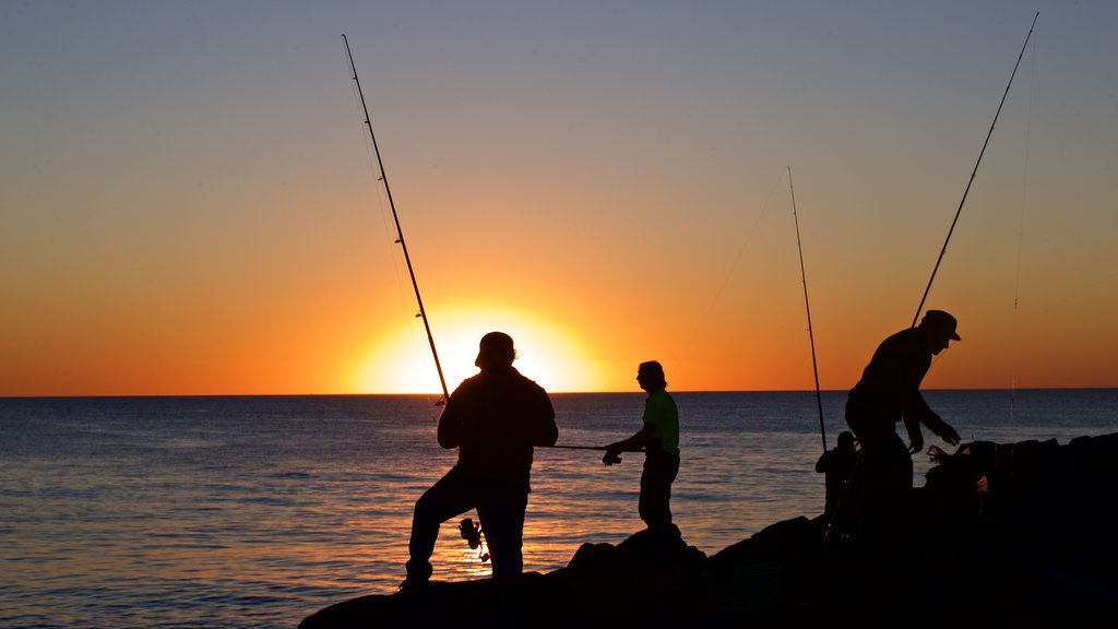 Cottesloe Beach which includes general coastal views, rocky coastline and fishing