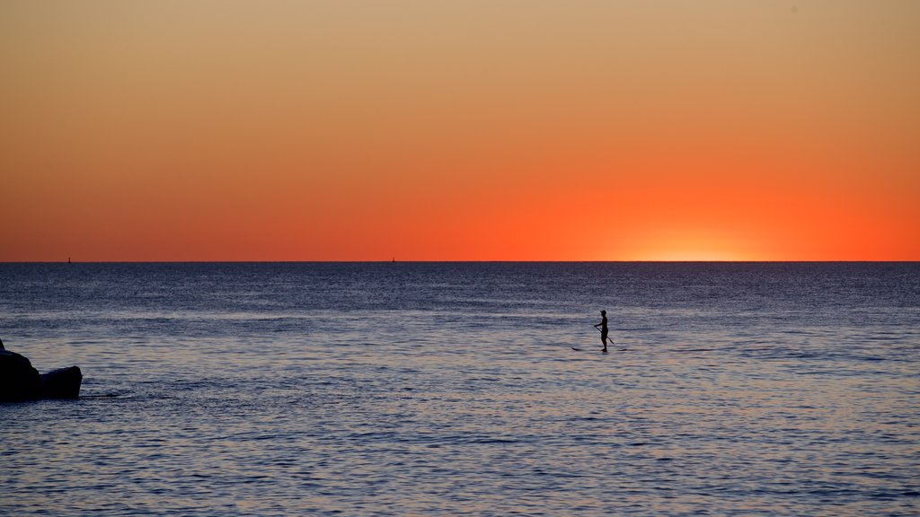 Cottesloe Beach showing general coastal views, kayaking or canoeing and a sunset