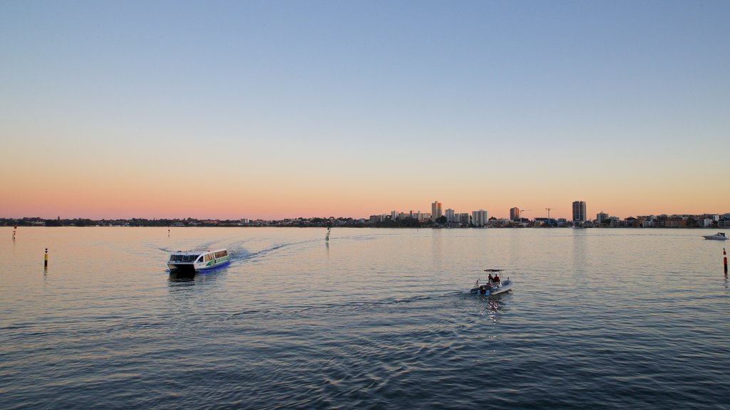 Elizabeth Quay featuring a sunset, boating and a bay or harbour