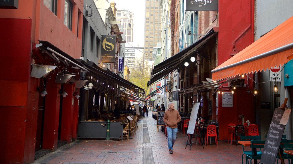 Hardware Lane showing street scenes as well as an individual male