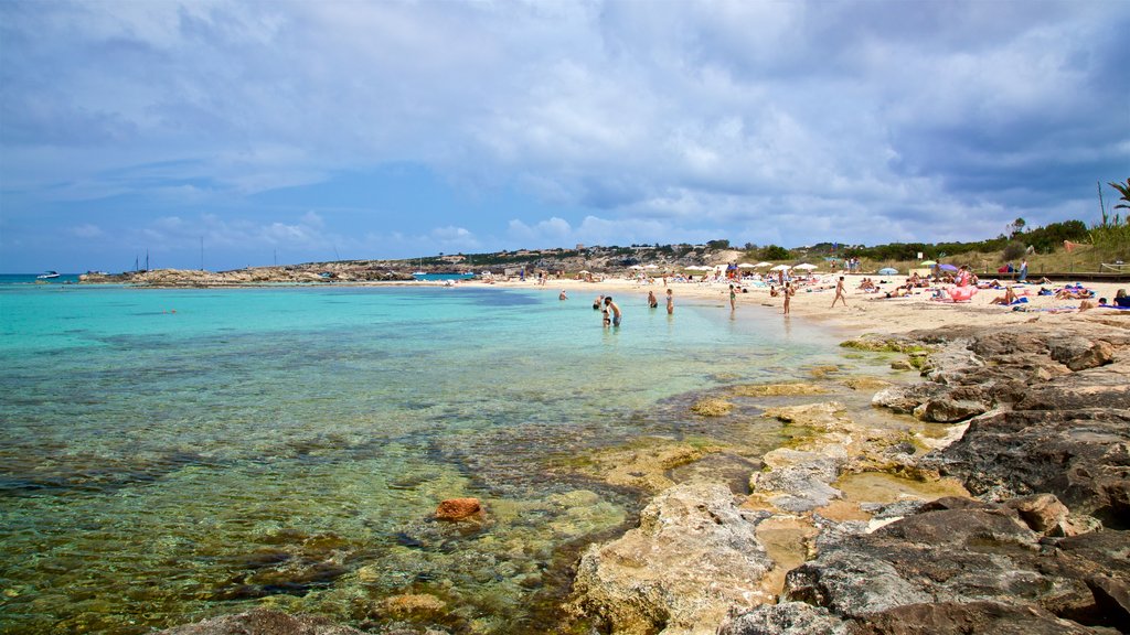 Es Pujols Beach showing rugged coastline, swimming and general coastal views