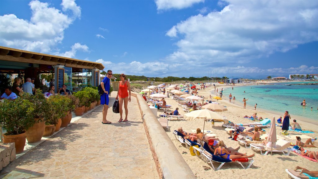 Es Pujols Beach showing a sandy beach, a coastal town and general coastal views