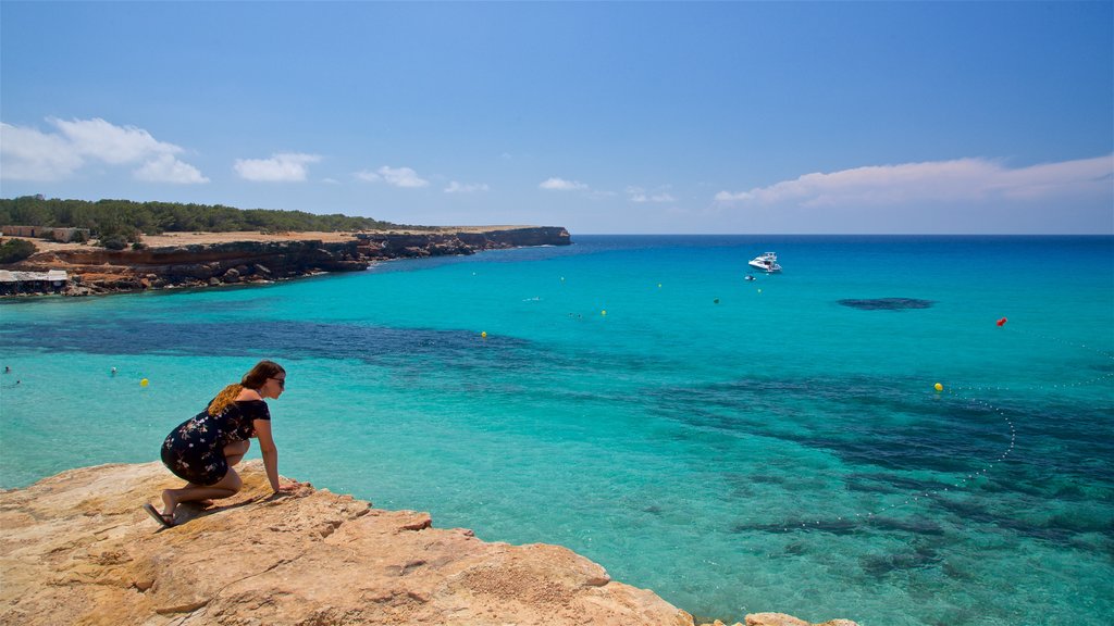 Cala Saona which includes rugged coastline and general coastal views as well as an individual femail