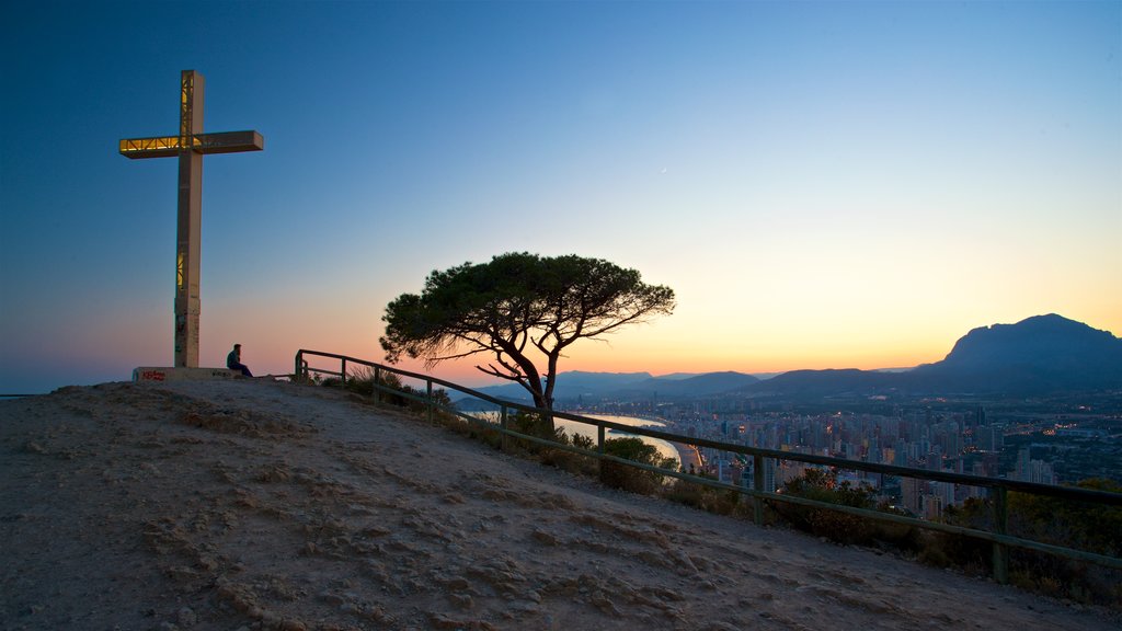 La Cruz Benidorm showing landscape views, a sunset and religious aspects