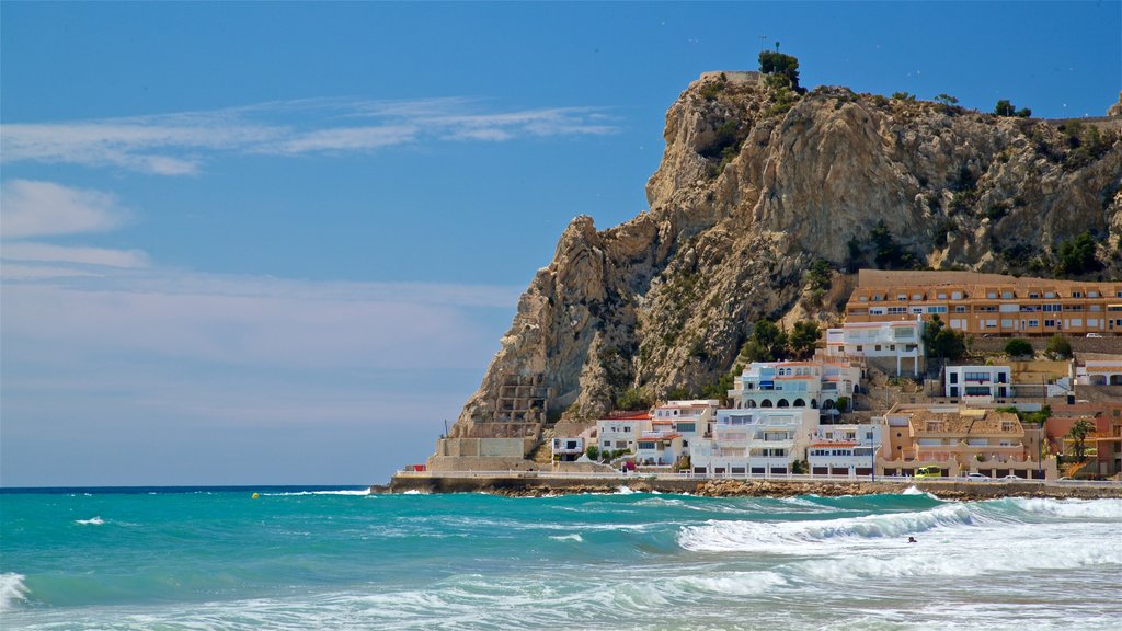 Poniente Beach showing rugged coastline, a coastal town and general coastal views