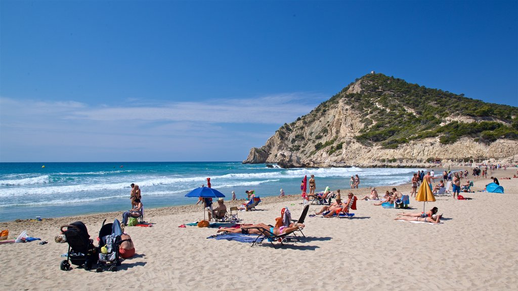 La Cala Beach which includes general coastal views and a sandy beach as well as a small group of people