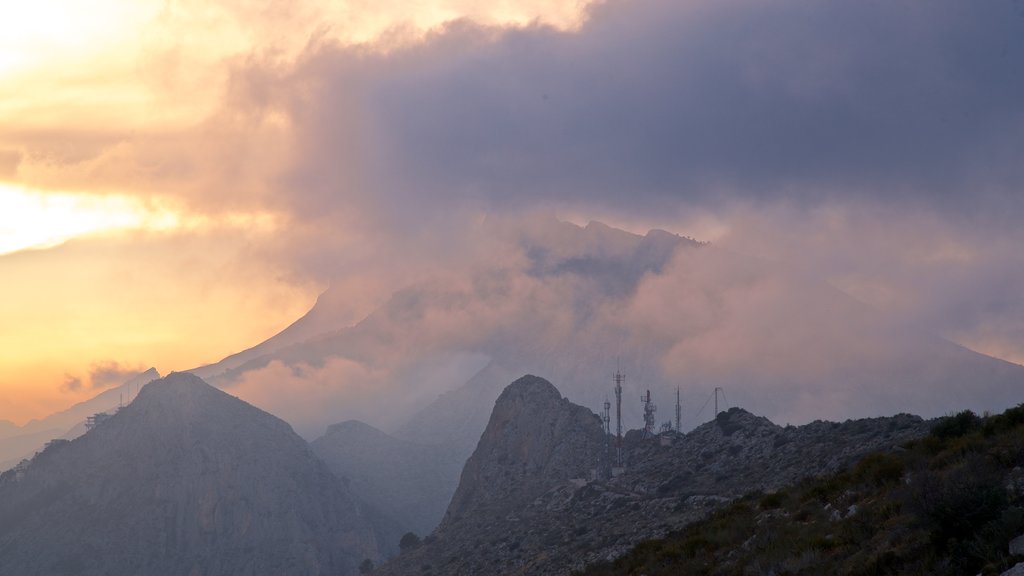 Mirador Monte Toix which includes a sunset, landscape views and mist or fog