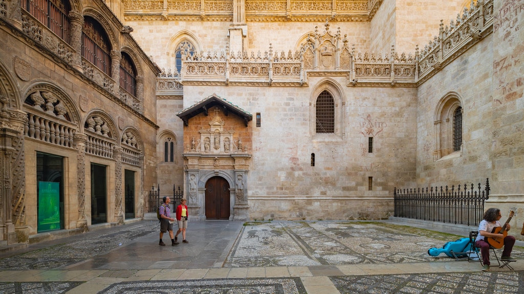 Granada Cathedral featuring heritage elements and street scenes as well as a couple