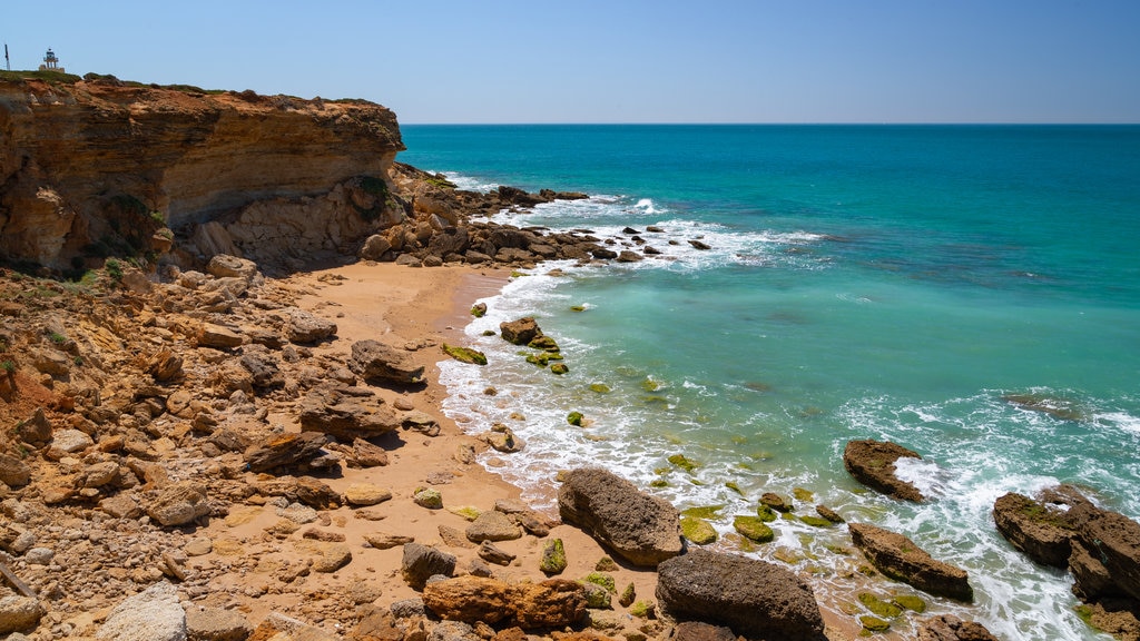 Cala del Faro showing rocky coastline, a sandy beach and general coastal views