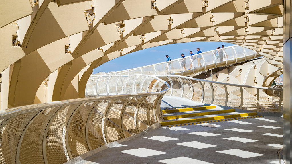 Metropol Parasol featuring a bridge as well as a small group of people