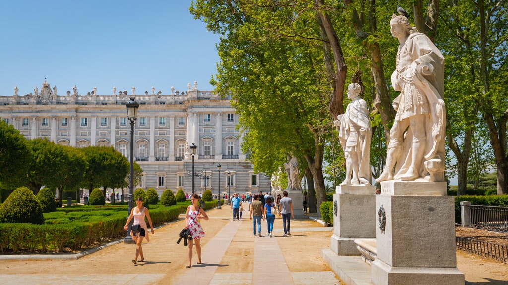 Plaza de Oriente featuring a statue or sculpture, a garden and heritage architecture