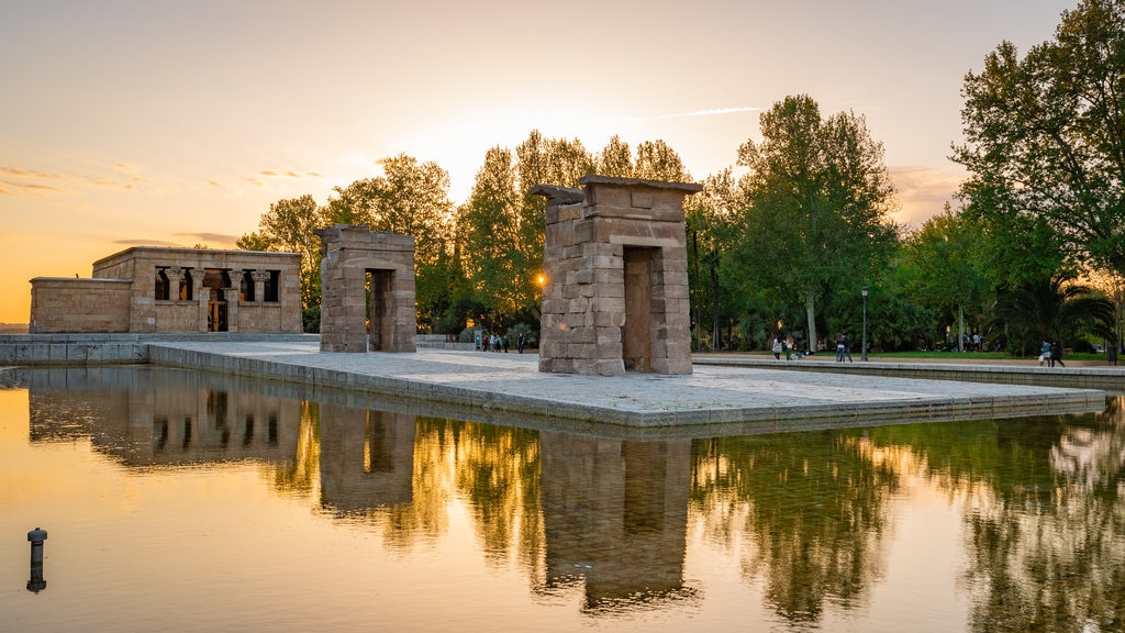 Temple of Debod featuring a fountain, a sunset and heritage elements