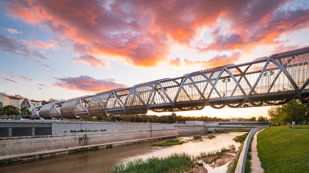 Puente Monumental Parque de Arganzuela featuring a bridge, a river or creek and a sunset