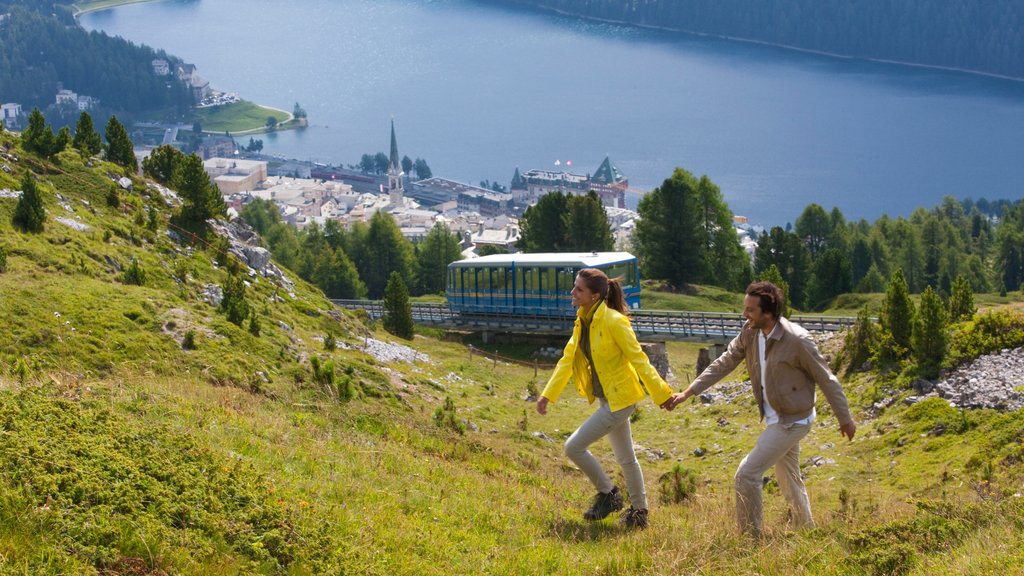 St. Moritz showing a lake or waterhole, hiking or walking and a small town or village