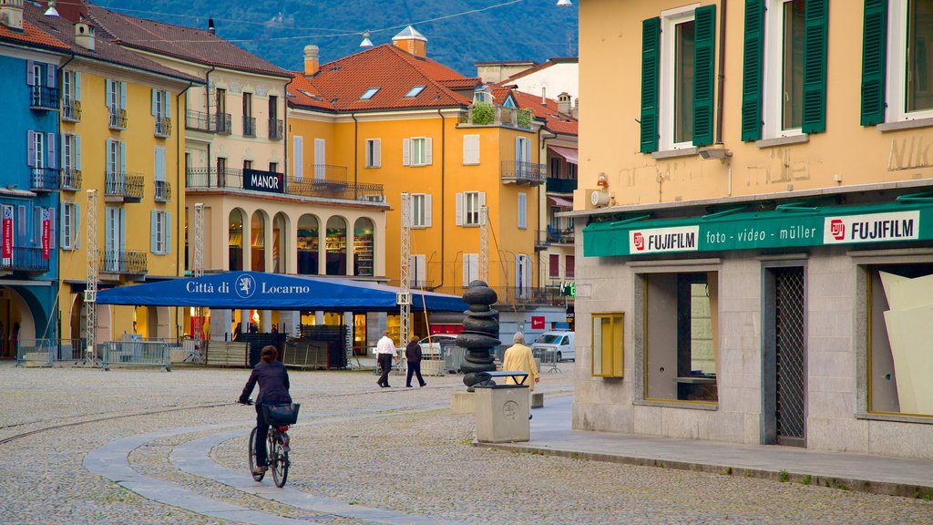 Piazza Grande showing road cycling as well as an individual femail