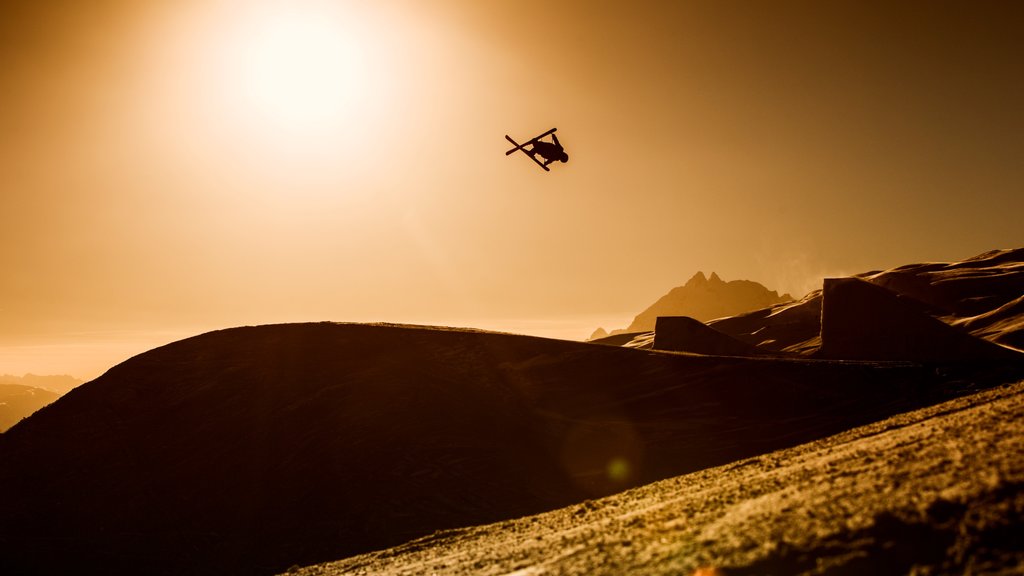 Laax Ski Resort which includes landscape views, a sunset and snow skiing