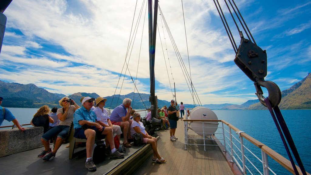 TSS Earnslaw Steamship showing boating and mountains as well as a large group of people