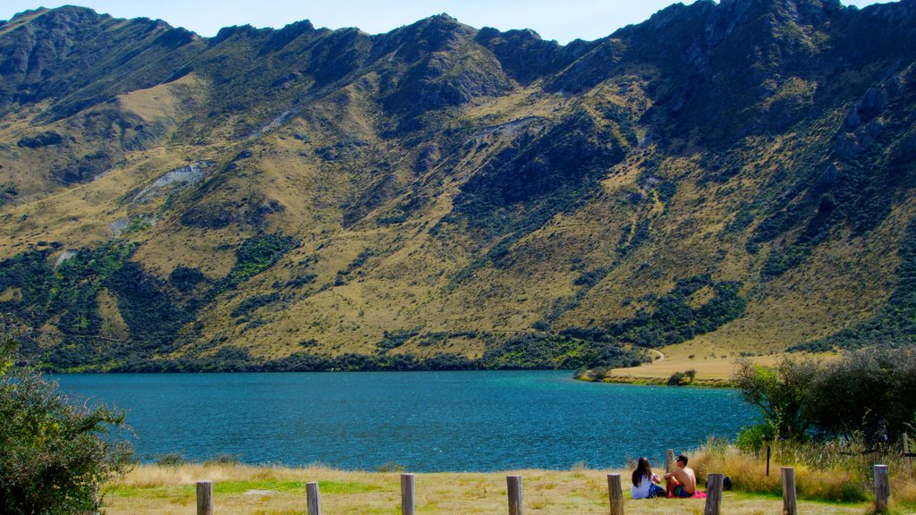 Queenstown featuring a lake or waterhole, hiking or walking and mountains