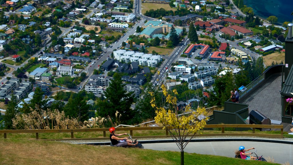 Skyline Gondola showing street scenes, motorbike riding and a city