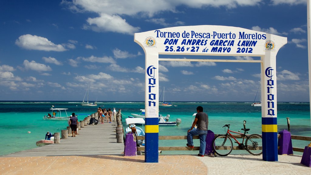 Puerto Morelos showing a marina, signage and general coastal views