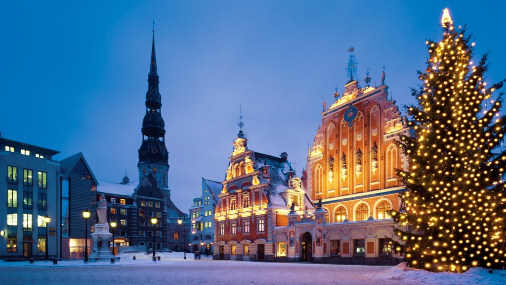 Riga featuring snow, night scenes and a city