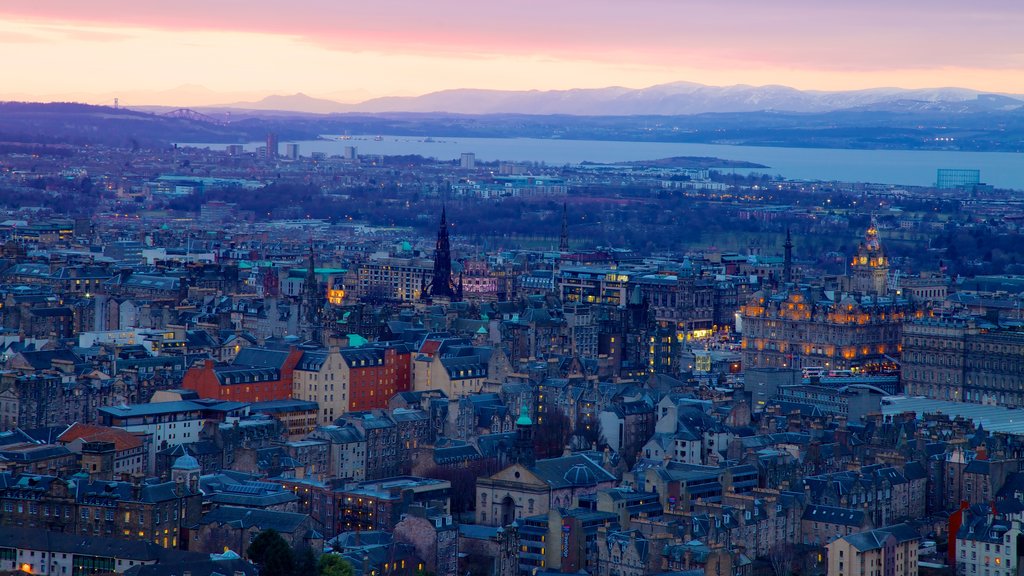 Arthur\\\'s Seat which includes a sunset and a city