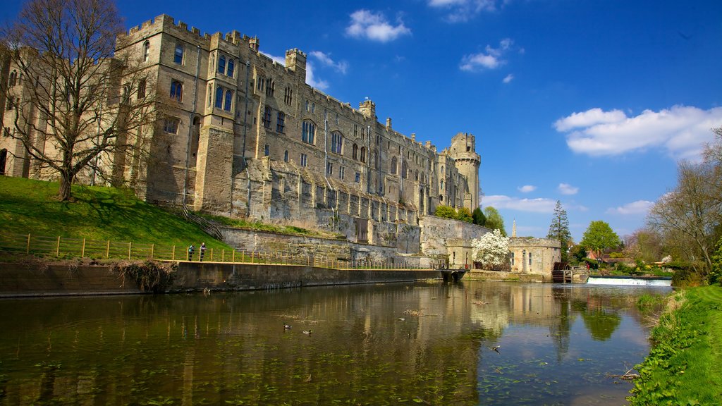 Warwick Castle featuring a river or creek, a castle and heritage architecture