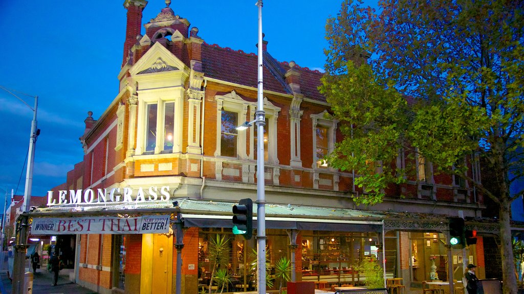 Lygon Street showing signage, heritage architecture and a city