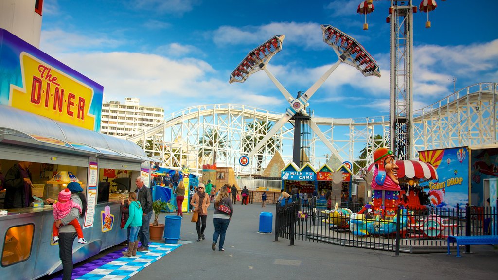 Luna Park featuring signage and rides as well as a large group of people