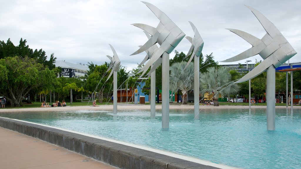 Cairns and Northern Beaches featuring a fountain, outdoor art and a pool